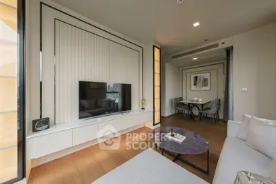 Modern living room with sleek design and dining area, featuring stylish furniture and elegant decor.