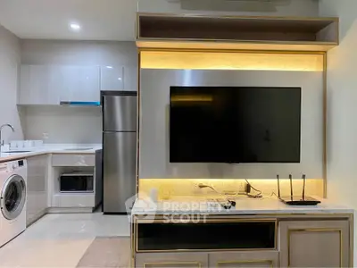 Modern living room with sleek TV setup and stylish kitchen appliances