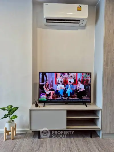 Modern living room with sleek TV stand and air conditioning unit