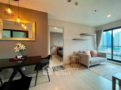 Modern living room with stylish decor and city view balcony in a high-rise apartment.