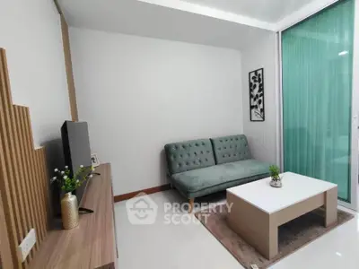 Modern living room with sleek furniture and large window for natural light.