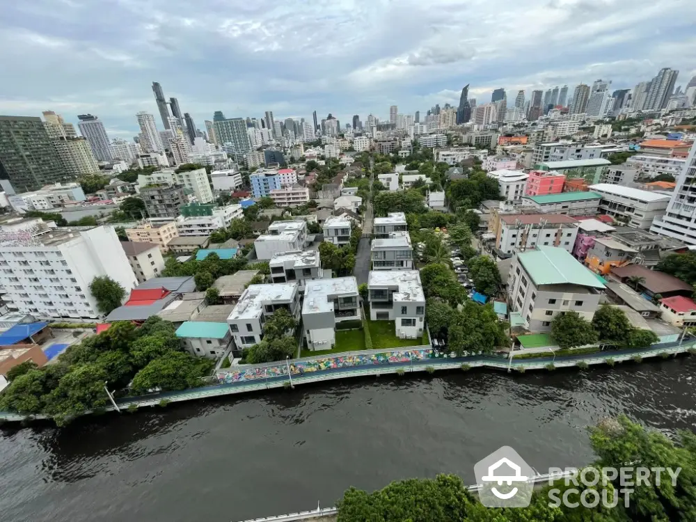 Stunning aerial view of urban skyline with river and modern buildings, perfect for city living enthusiasts.