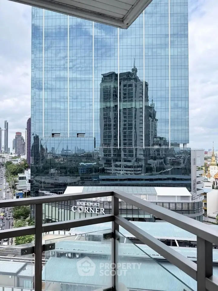 Stunning city view from a modern balcony with glass railing, perfect for urban living.