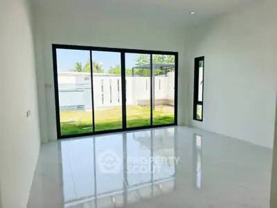 Spacious living room with large windows and garden view in modern home