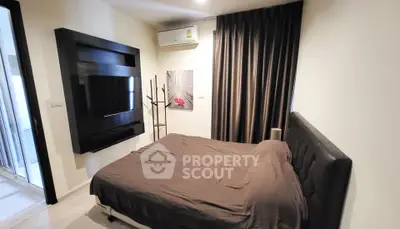 Modern bedroom with sleek black furniture and cozy ambiance