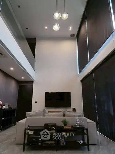 Modern living room with high ceiling and stylish decor