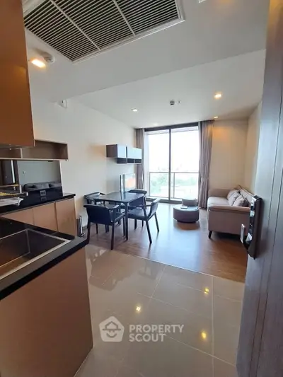 Modern open-plan living room with dining area and large window view