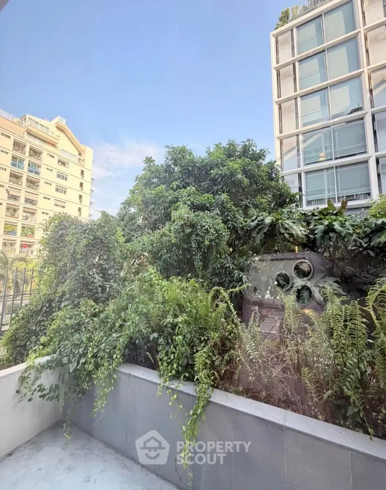Lush garden view from modern apartment balcony in urban setting