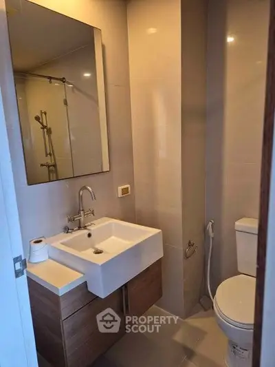 Modern bathroom with sleek fixtures and elegant design, featuring a stylish vanity and contemporary shower.
