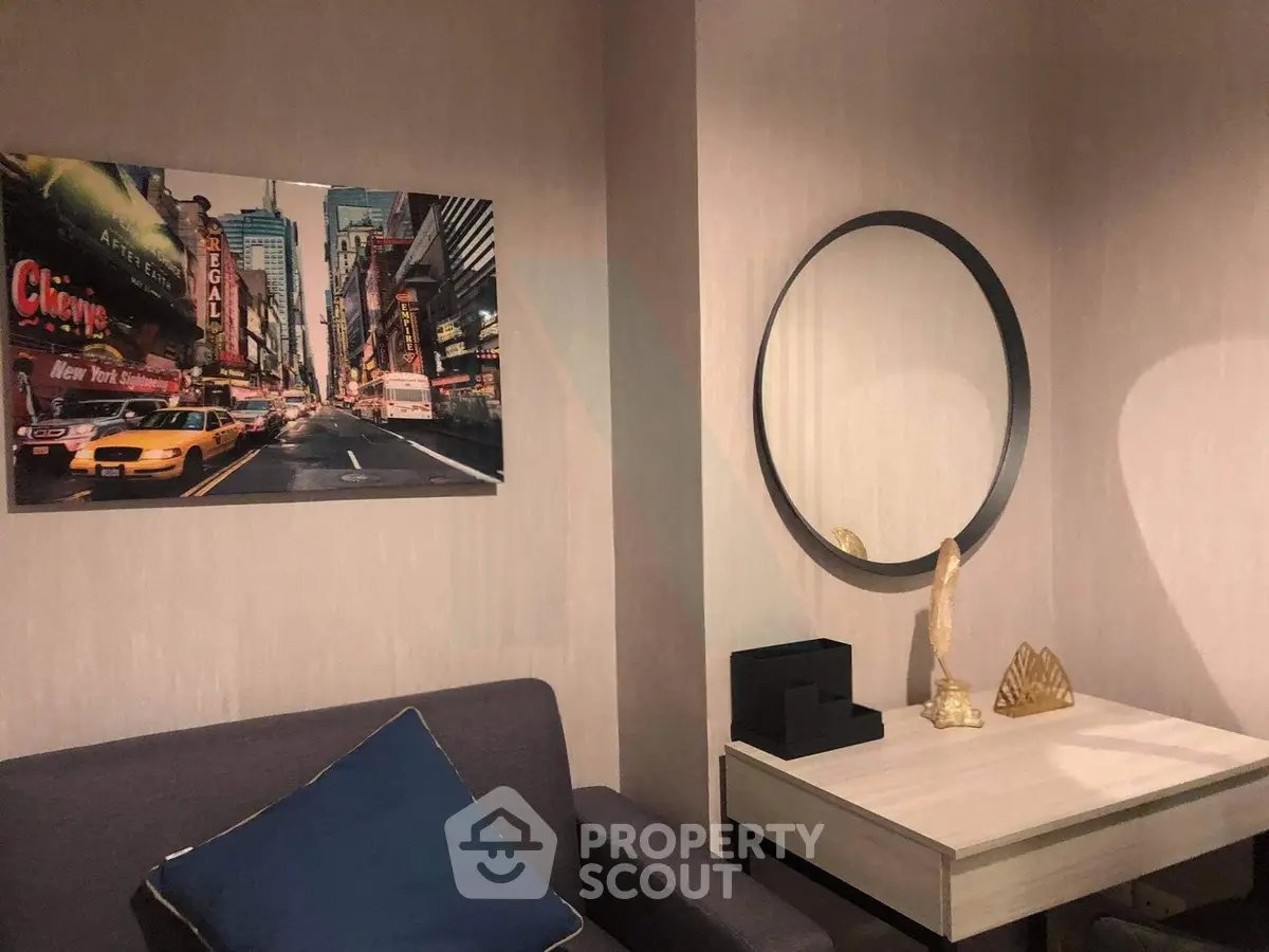 Chic modern living room with stylish decor and wall art, featuring a cozy sofa and elegant mirror.