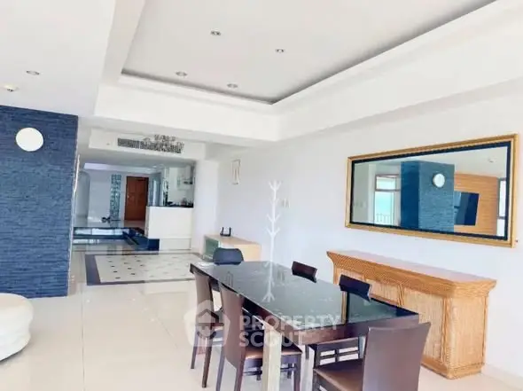 Spacious modern dining area with elegant decor and ample natural light.