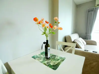 Charming living room with cozy seating and vibrant floral centerpiece, perfect for relaxation.