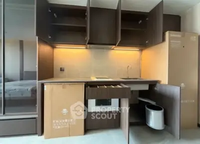 Modern kitchen with sleek cabinetry and built-in appliances in a compact layout.