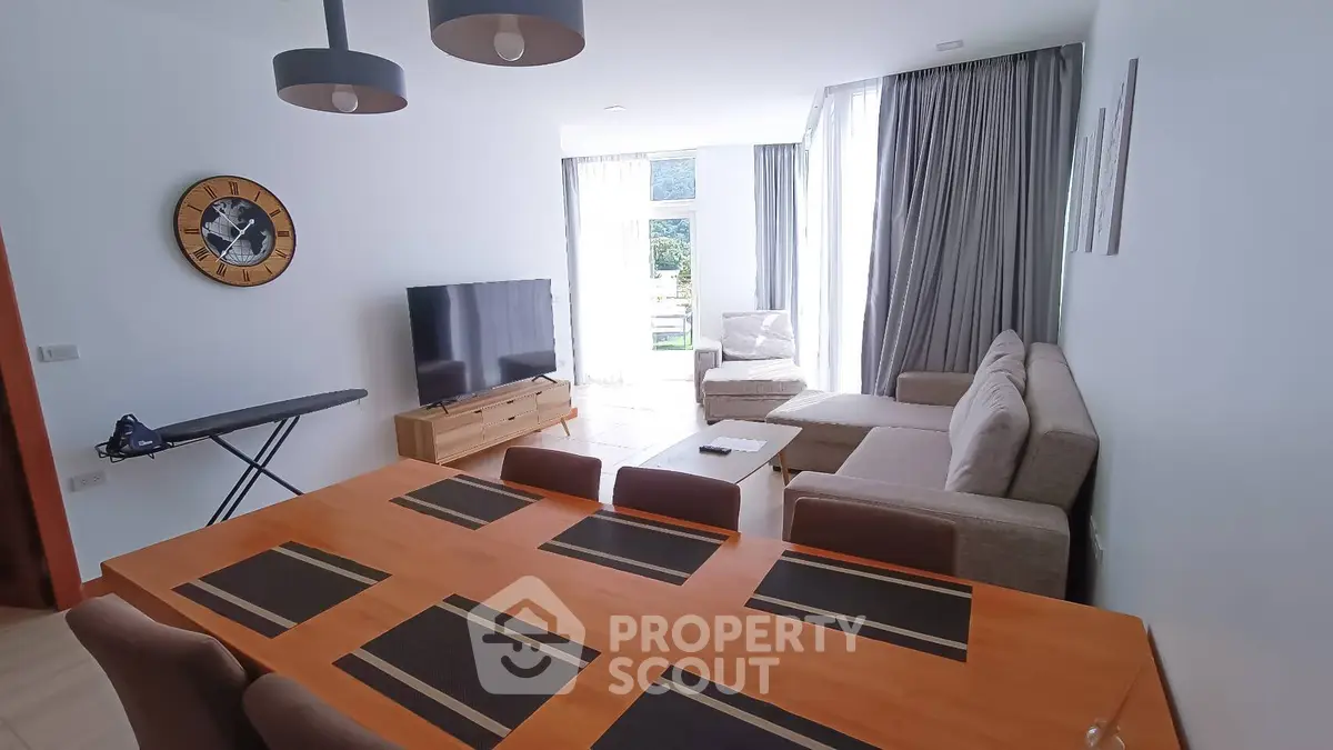 Spacious living room with modern decor and large windows offering natural light.