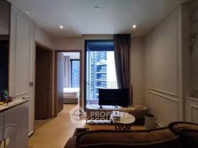 Modern living room with stylish decor and city view from the window, featuring a cozy seating area and TV.