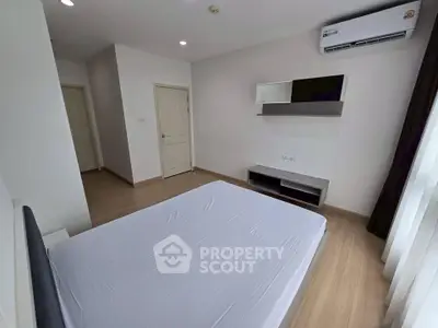 Modern minimalist bedroom with air conditioning and natural light