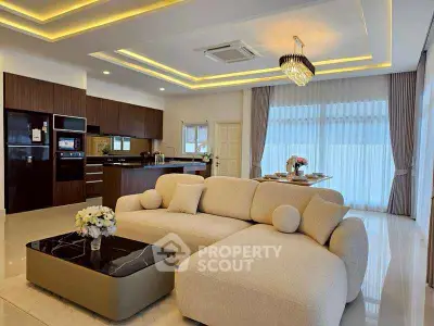 Luxurious open-plan living room with modern kitchen and elegant lighting