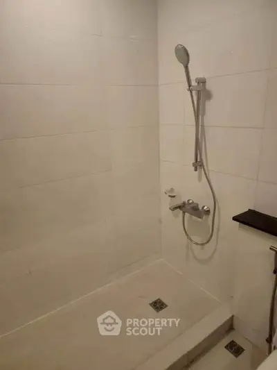 Modern bathroom with sleek shower fixtures and minimalist design.