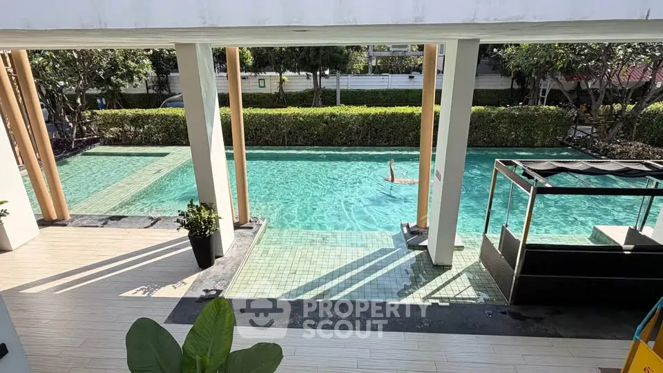 Luxurious poolside view with lush greenery and modern design elements.