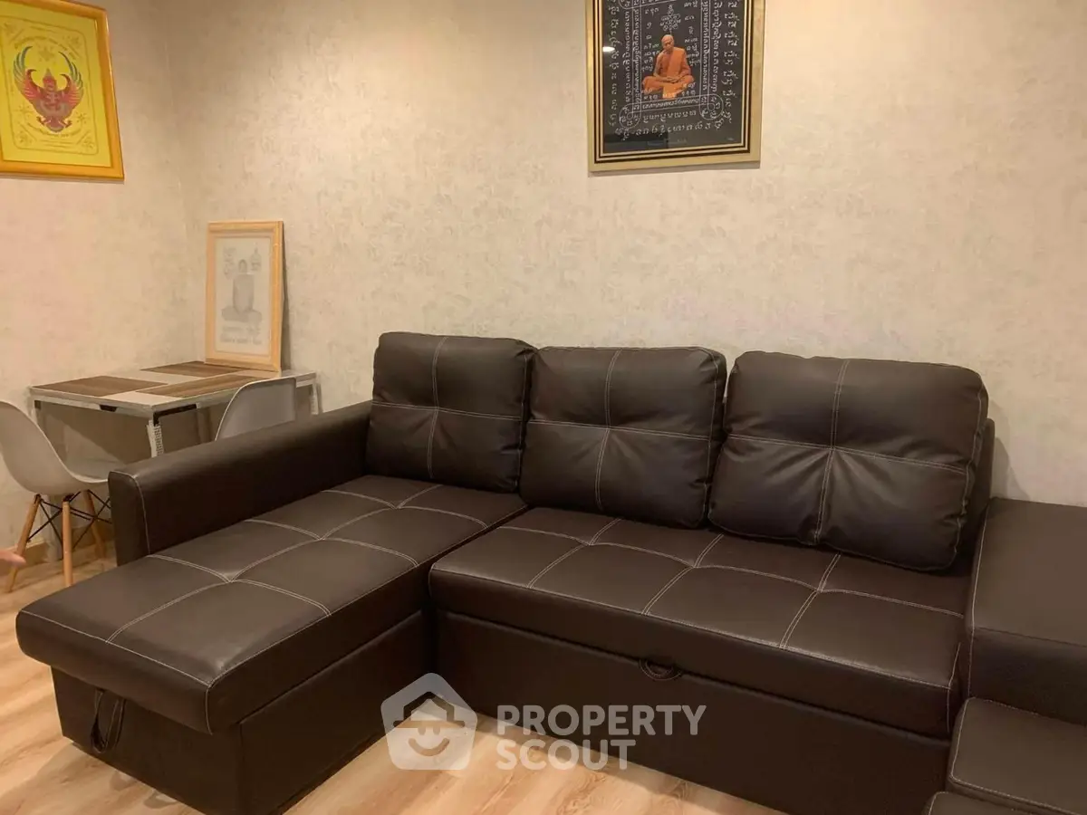 Cozy living room with stylish brown leather sectional sofa and modern decor.