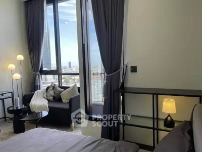 Luxurious bedroom with stunning city view and elegant decor in high-rise apartment.
