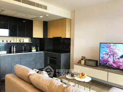 Modern living room with open kitchen, sleek cabinetry, and stylish decor in a contemporary apartment.