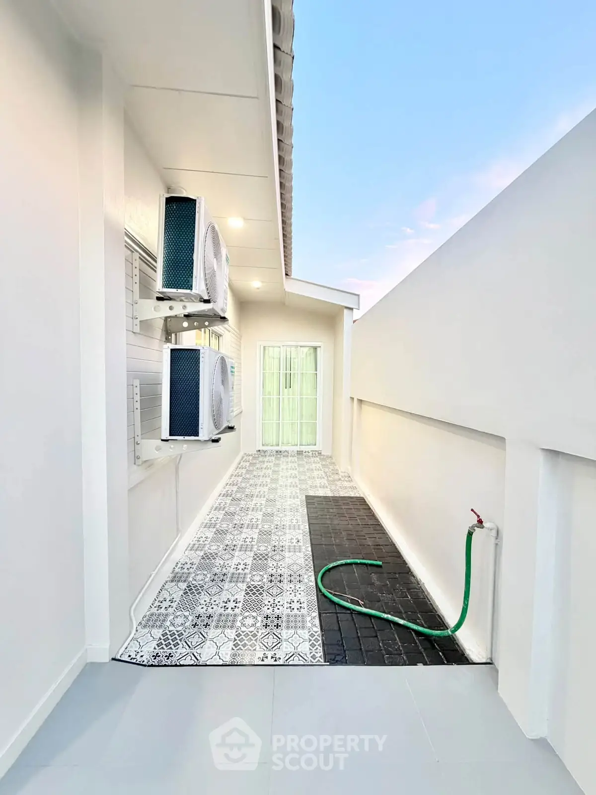 Modern outdoor space with air conditioning units and stylish tile flooring