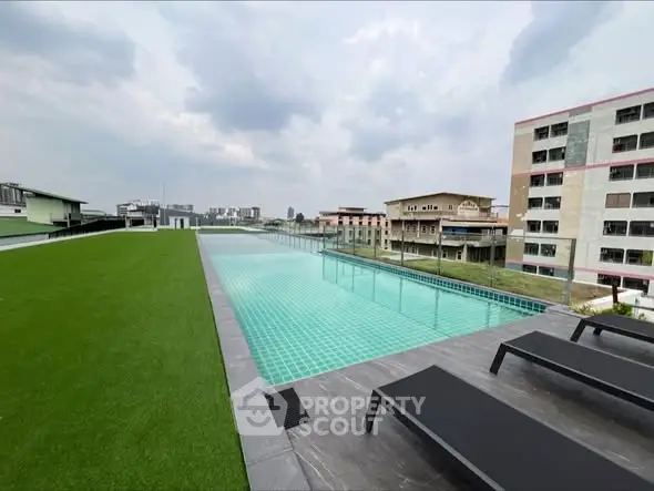 Luxurious rooftop pool with stunning city views and modern lounge chairs.