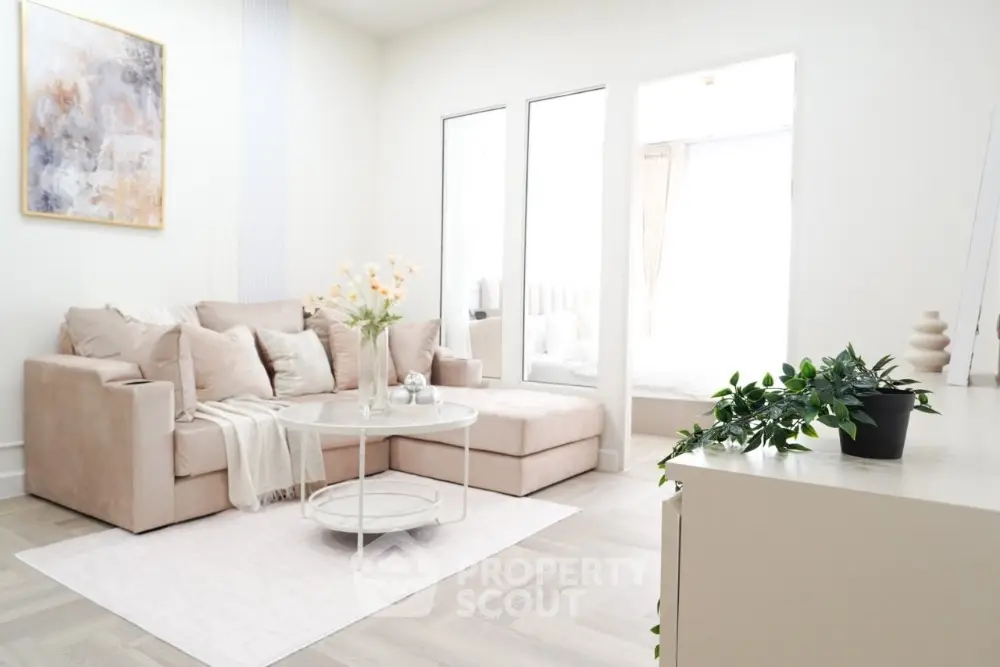 Bright and airy living room with modern beige sofa and chic decor
