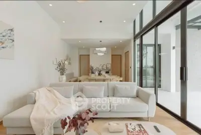 Spacious modern living room with large glass doors and elegant decor