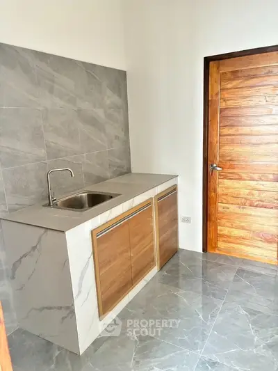 Modern kitchen with sleek marble countertops and wooden cabinetry