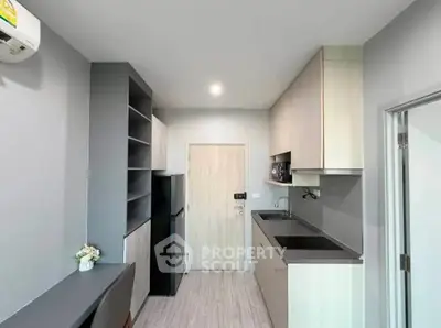 Modern kitchen with sleek cabinetry and built-in appliances in a compact layout.