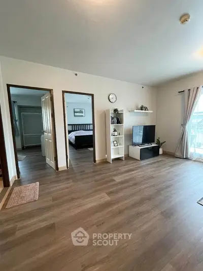 Spacious living room with modern decor and wooden flooring