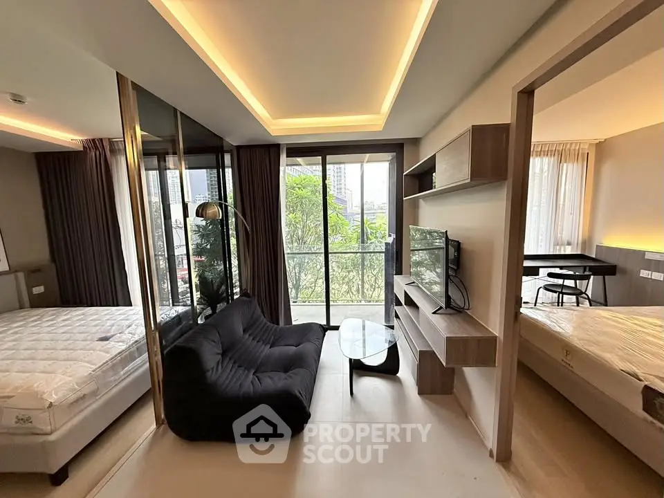 Modern apartment interior with spacious living area and large windows offering city views.