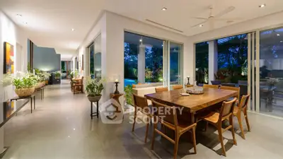 Luxurious open-plan living room with elegant dining area and garden view