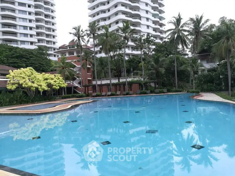 Luxurious residential complex with stunning pool and lush greenery