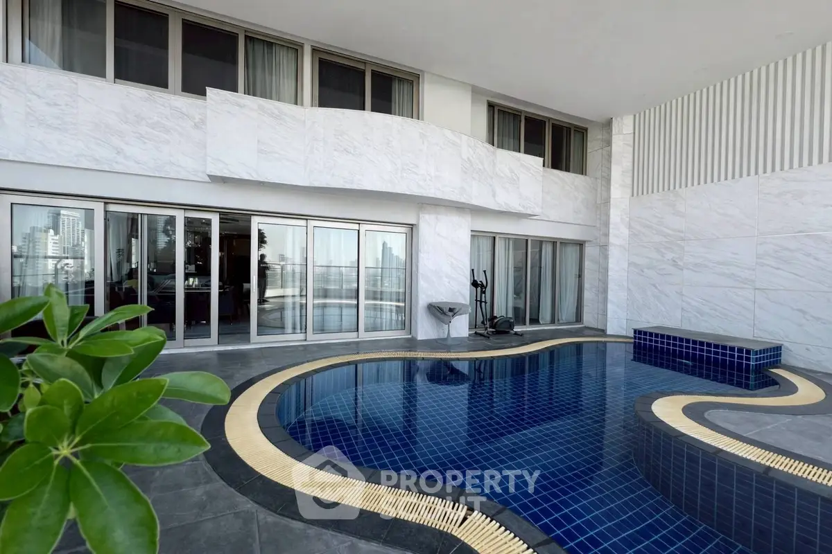 Luxurious poolside view of modern apartment with sleek design and cityscape backdrop.