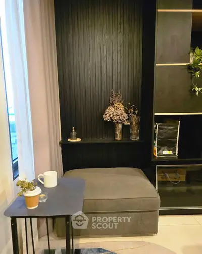 Cozy corner with modern decor and natural light, perfect for relaxation.