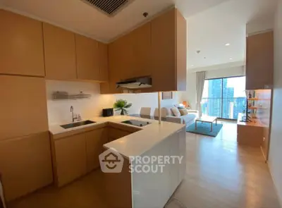 Modern open-layout kitchen with sleek cabinetry and spacious living area with city view.