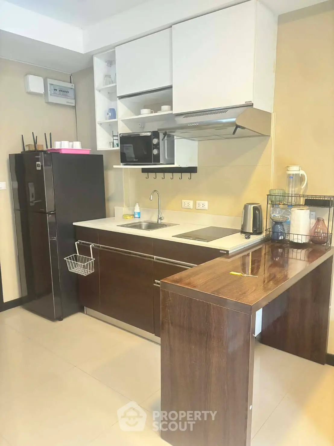 Modern kitchen with sleek cabinetry and appliances in a compact layout