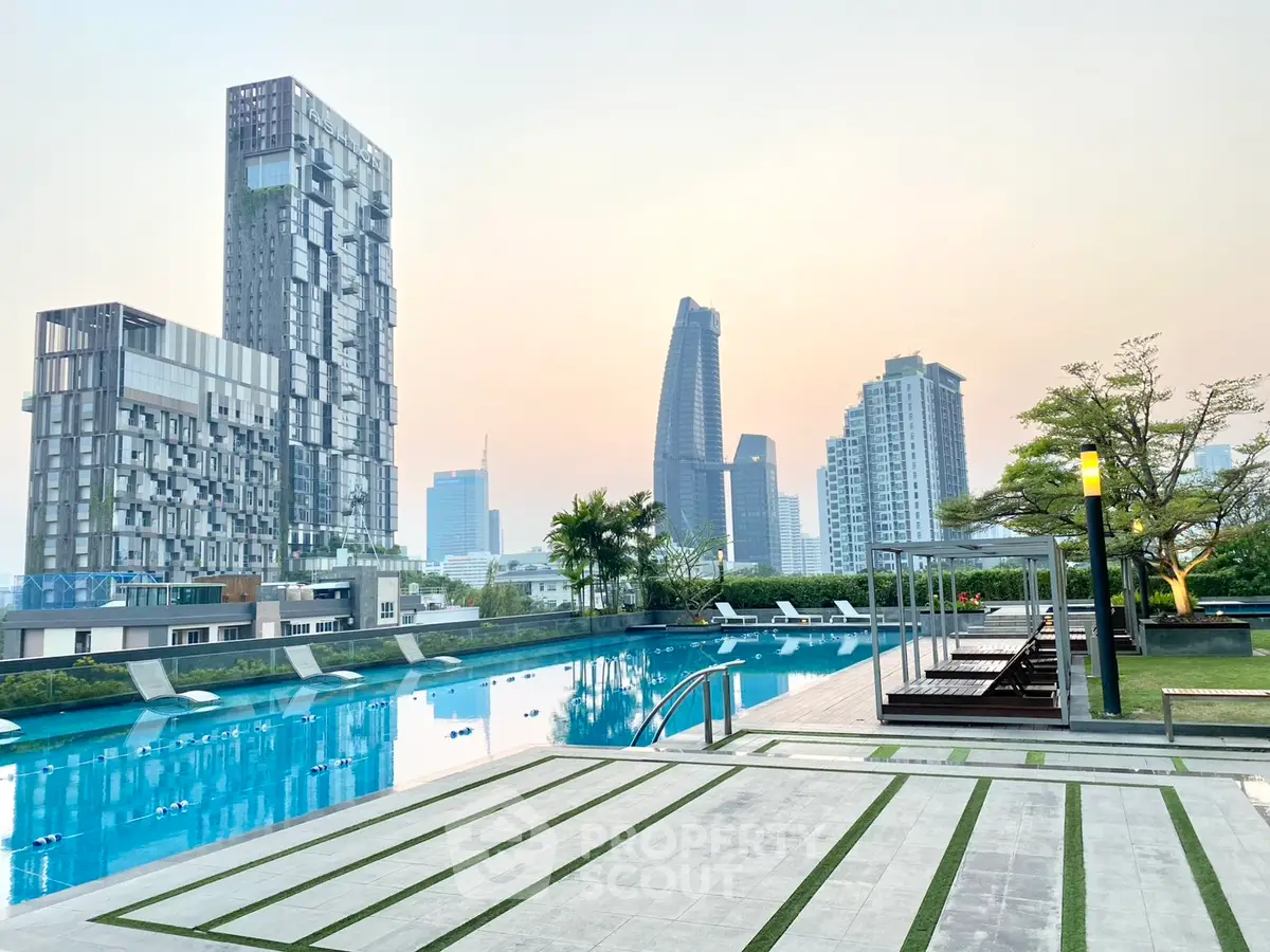 Luxurious rooftop pool with stunning city skyline views at sunset.