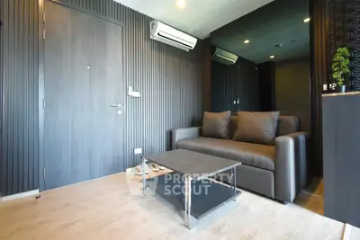 Modern living room with sleek design, featuring a comfortable sofa and stylish coffee table.
