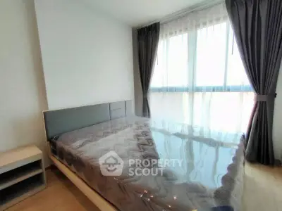 Modern bedroom with large window and stylish curtains, perfect for natural light lovers.