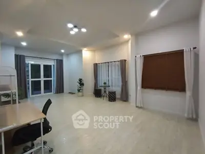 Spacious modern living room with large windows and stylish decor