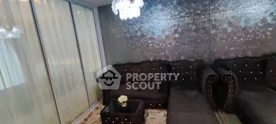 Luxurious living room with elegant black sofa and crystal chandelier