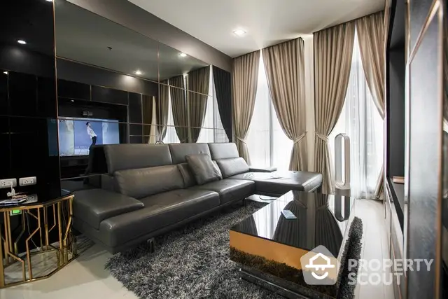 Luxurious modern living room with sleek black furniture and floor-to-ceiling windows.