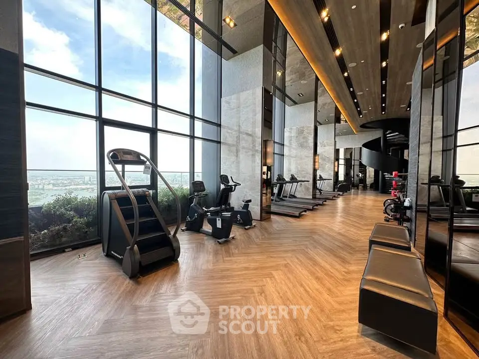 Luxurious high-rise gym with panoramic city views and modern fitness equipment.