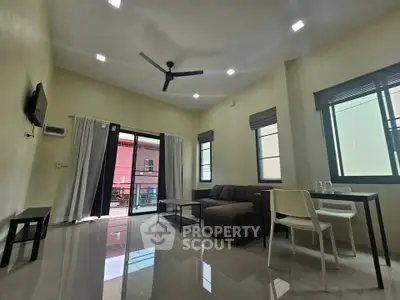 Spacious modern living room with sleek furniture and large windows for natural light.