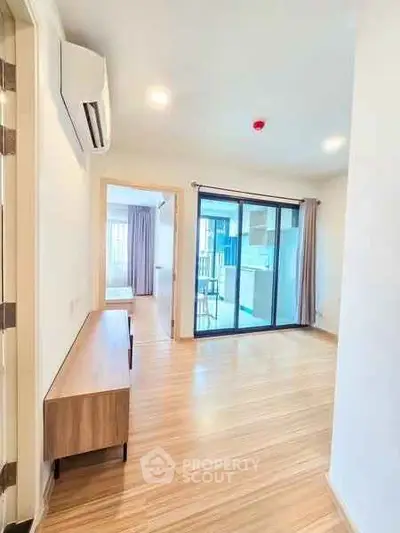Bright modern apartment interior with wooden flooring and large windows