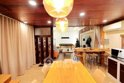 Spacious open-plan living area with modern kitchen and stylish dining space, perfect for entertaining.
